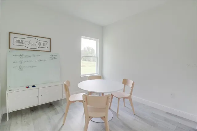 a dining room with furniture and window