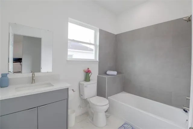 a bathroom with a sink a toilet and bathtub