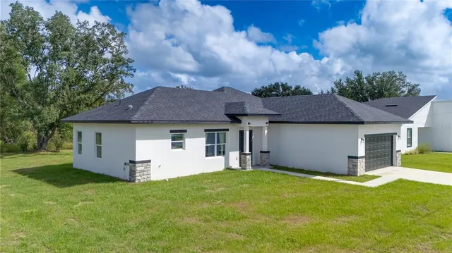 a front view of house with yard and green space