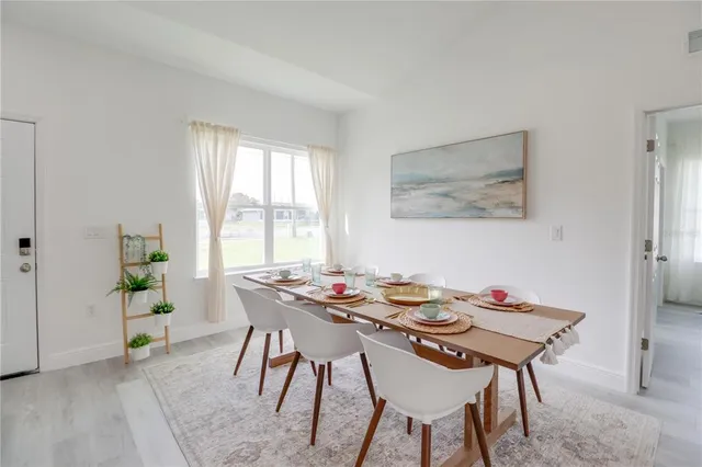 a dining room with furniture and window