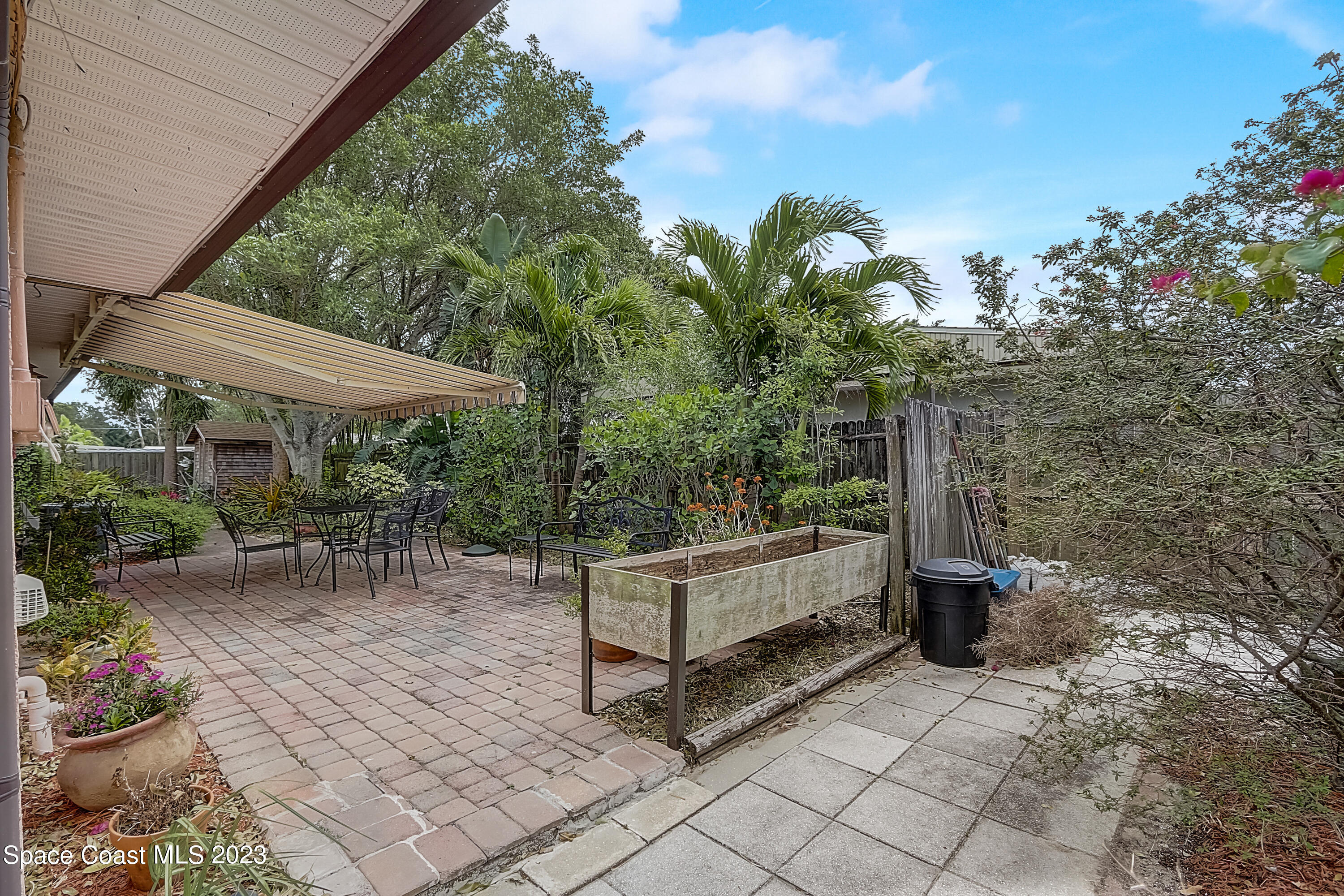 201 Cherry Street Melbourne, FL 32901 - Photo 17 of 22 a view of patio with a table and chairs and potted plants
