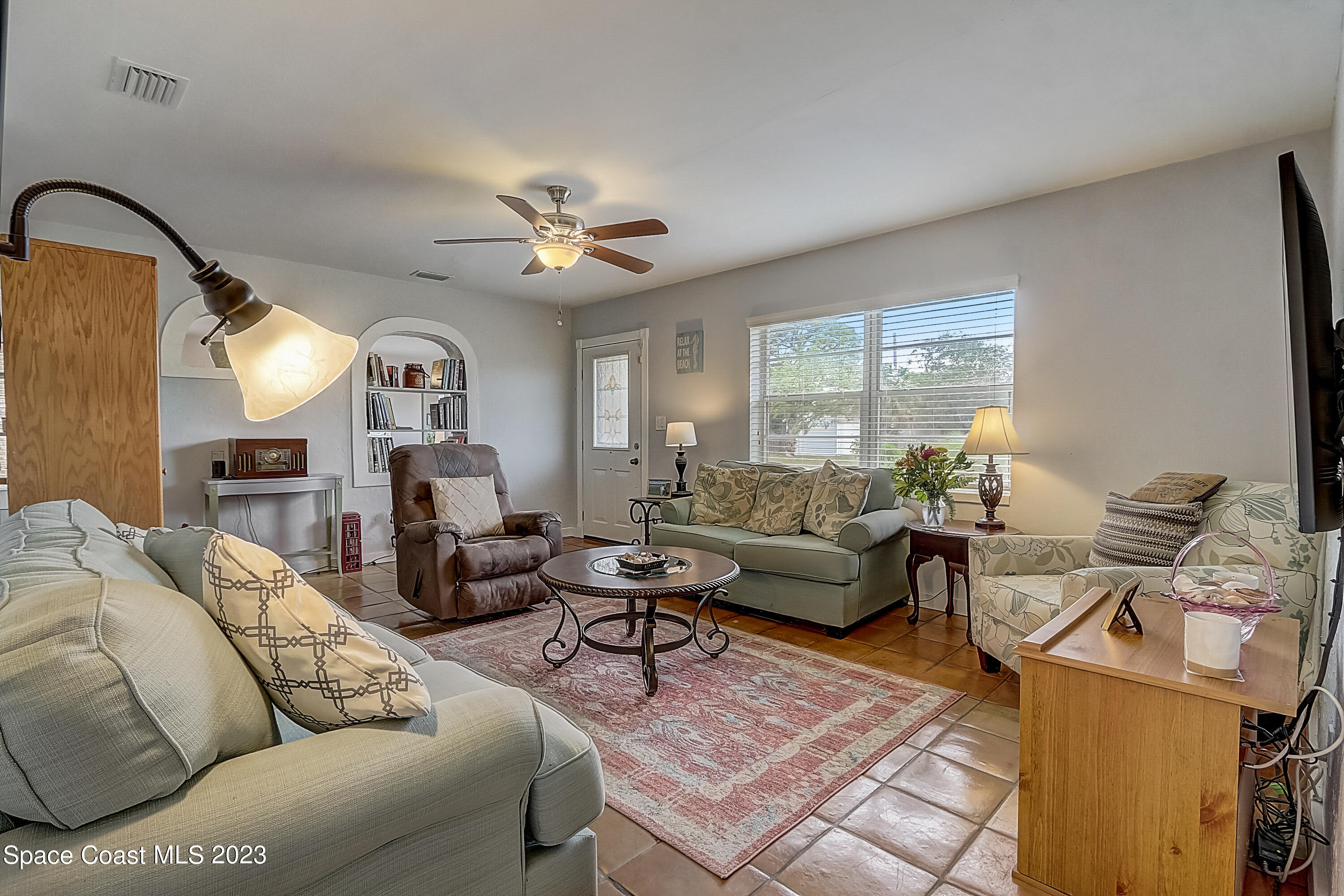 201 Cherry Street Melbourne, FL 32901 - Photo 6 of 22 a living room with furniture a ceiling fan and a window
