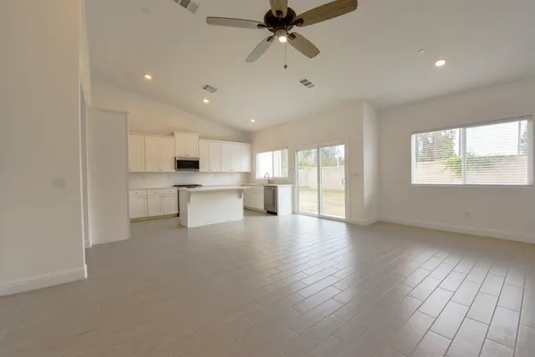 a view of a kitchen with refrigerator and wooden floor