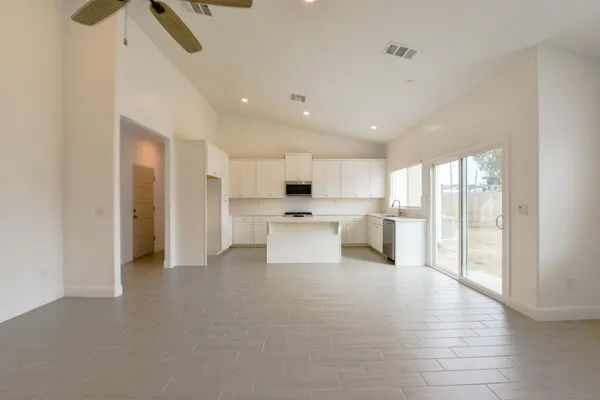 a kitchen with white cabinets stainless steel appliances and sink