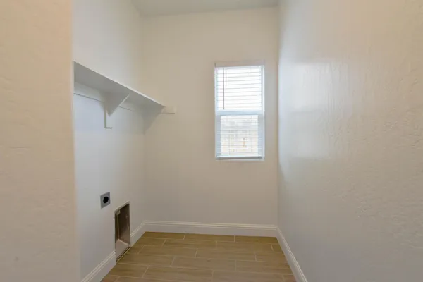 a view of a hallway with wooden shelves