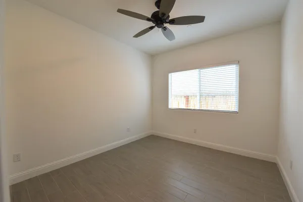 a view of a kitchen with a sink and a refrigerator