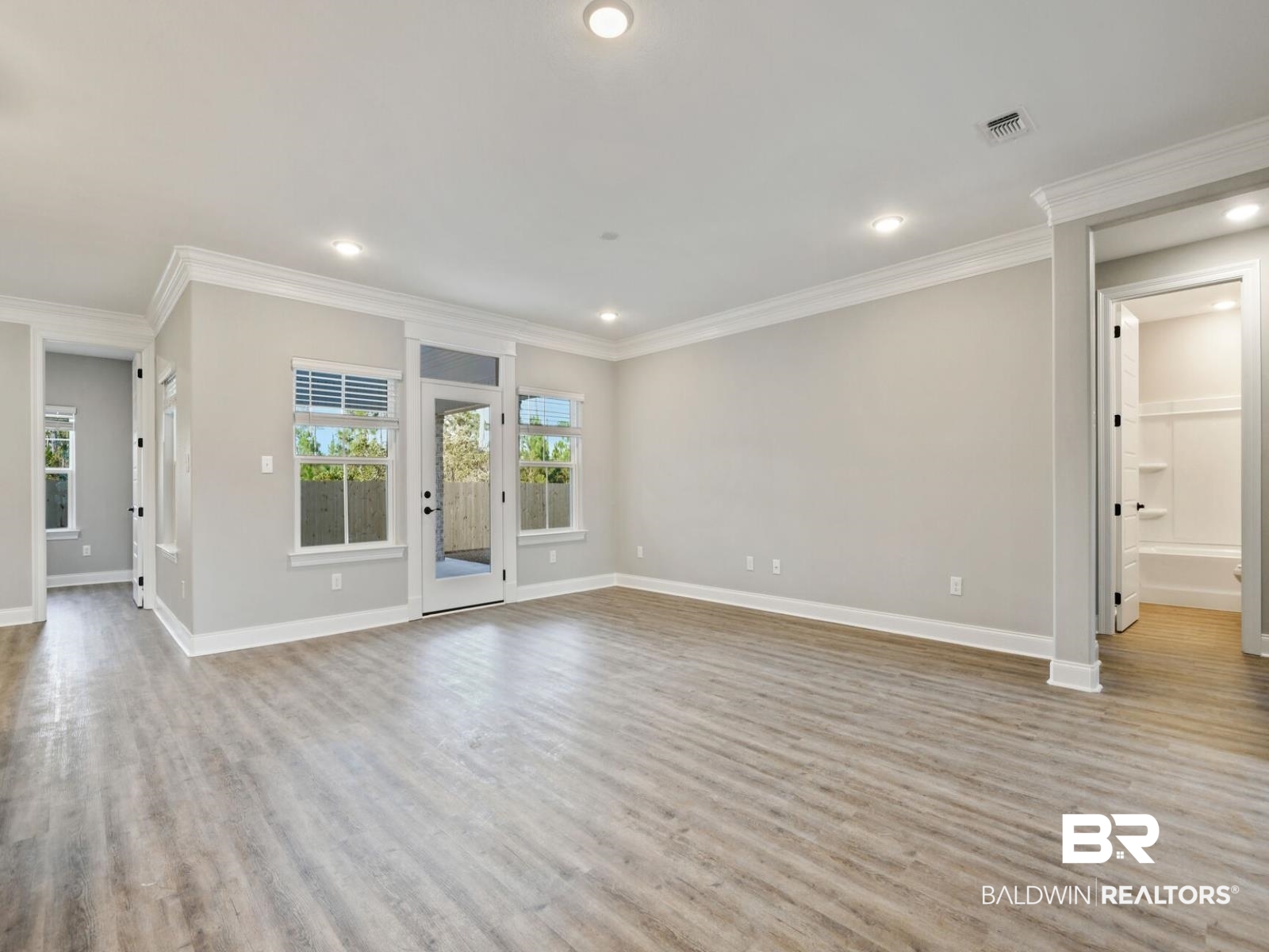 12943 Gondala Street Elberta, AL 36530 - Photo 8 of 23 Unfurnished living room featuring crown molding, light wood finished floors, and recessed lighting