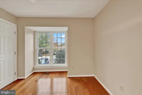 a view of a room with wooden floor and window