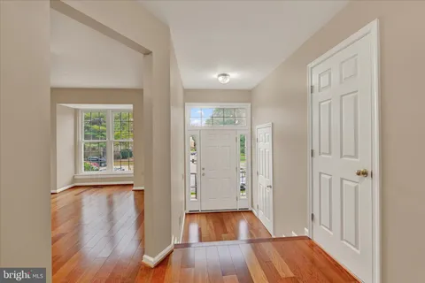 a view of a room with wooden floor and window