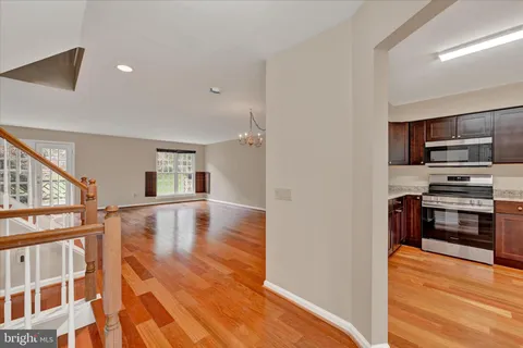 a view of kitchen and microwave with wooden floor