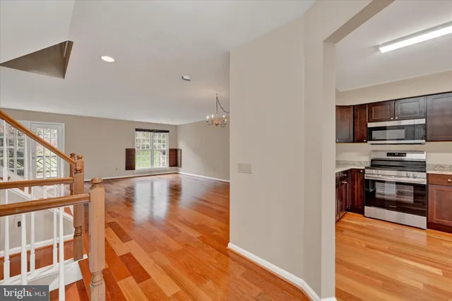 a view of kitchen and microwave with wooden floor