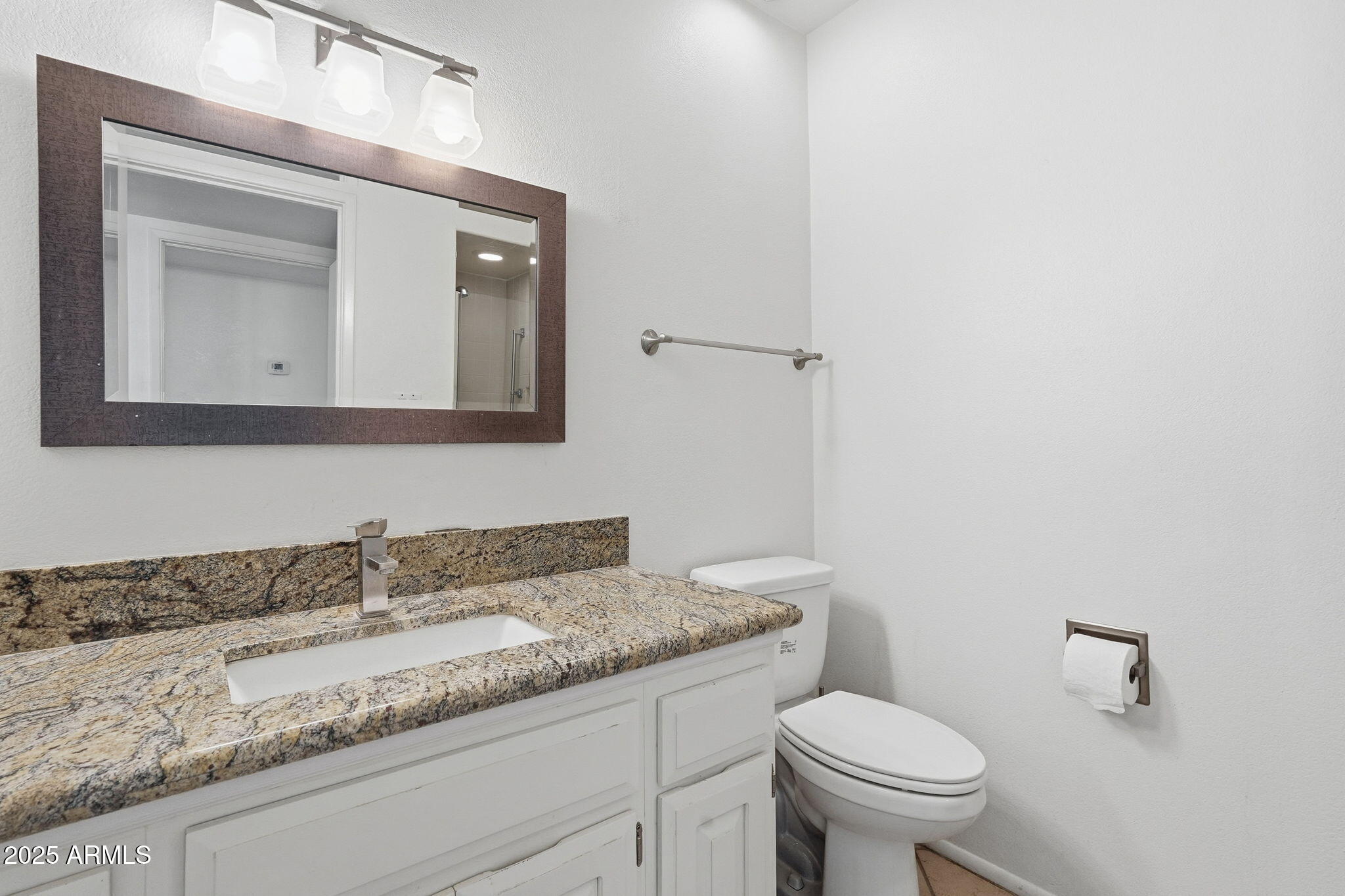 2131 East Bethany Home Road Phoenix, AZ 85016 - Photo 16 of 54 a bathroom with a granite countertop toilet sink and mirror