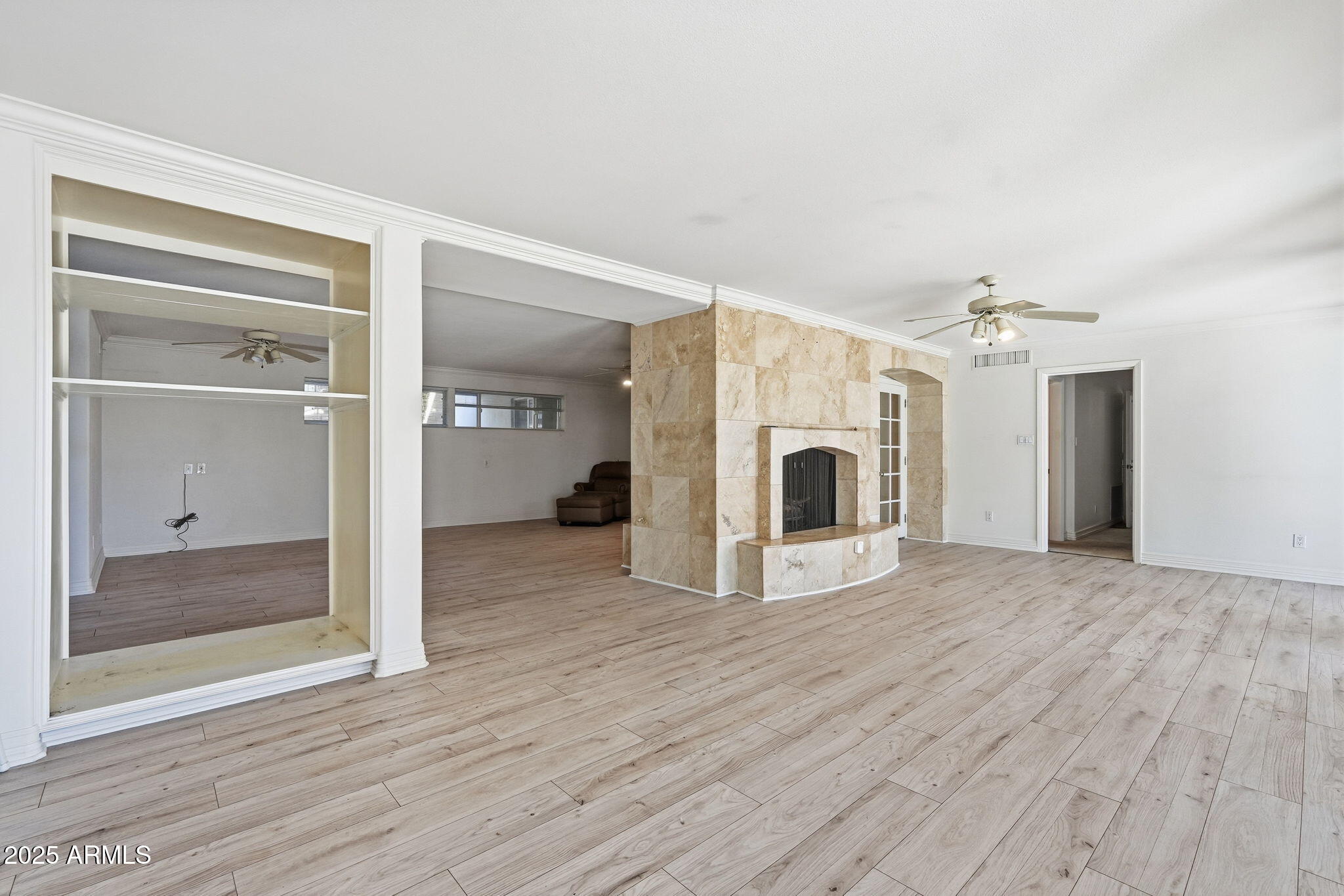 2131 East Bethany Home Road Phoenix, AZ 85016 - Photo 21 of 54 a view of a big room with wooden floor and a ceiling fan