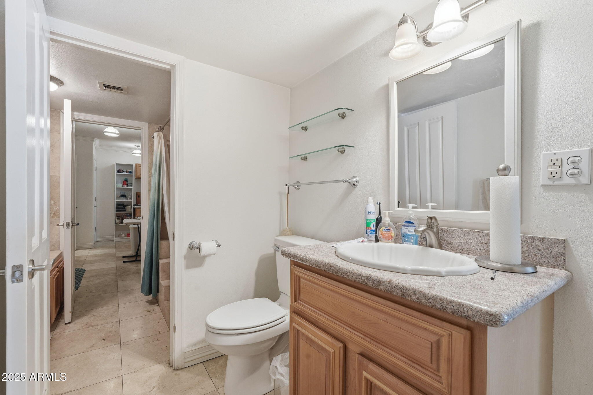 2131 East Bethany Home Road Phoenix, AZ 85016 - Photo 26 of 54 a bathroom with a granite countertop sink a toilet a mirror and shower