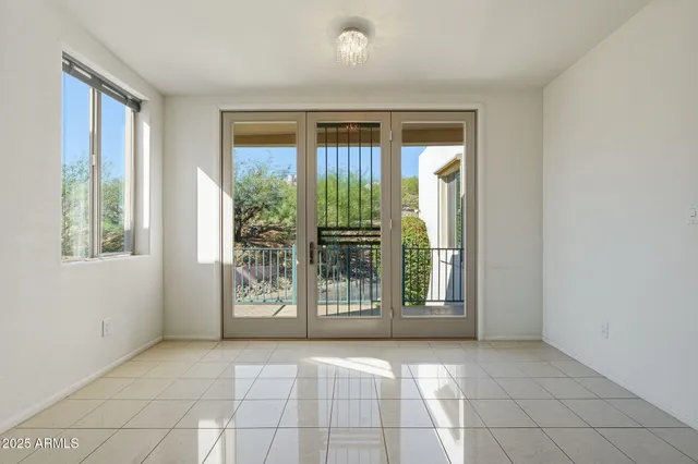a room with stainless steel appliances granite countertop a refrigerator and wooden cabinets