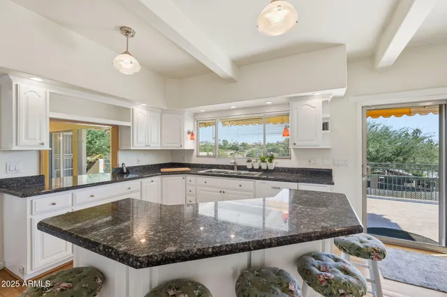 a living room with furniture pool table and a floor to ceiling window