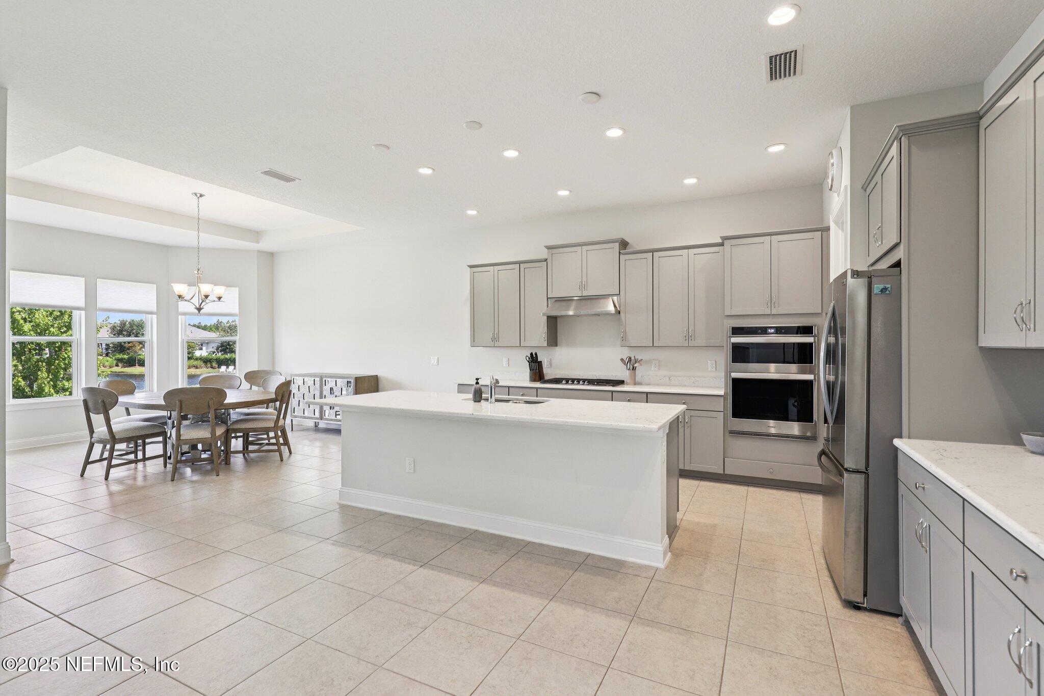 194 Snowbell Court St. Augustine, FL 32095 - Photo 13 of 89 a large white kitchen with lots of counter space and furniture