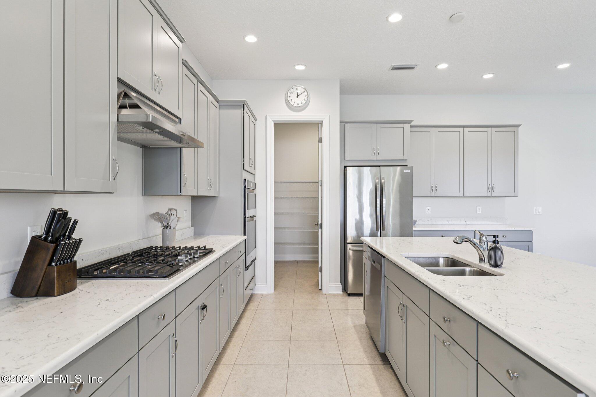 194 Snowbell Court St. Augustine, FL 32095 - Photo 14 of 89 a kitchen with stainless steel appliances granite countertop a sink stove and refrigerator