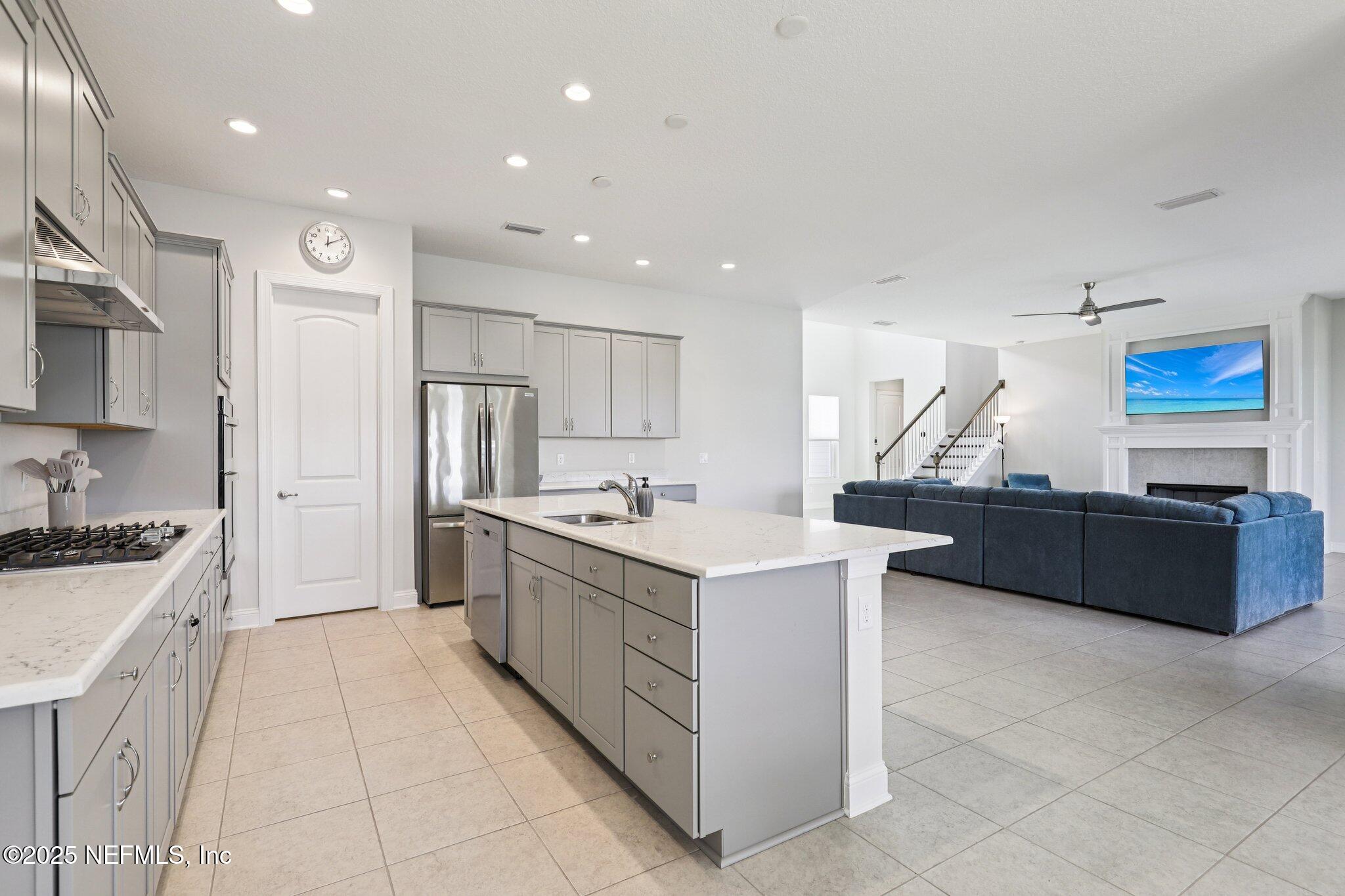 194 Snowbell Court St. Augustine, FL 32095 - Photo 15 of 89 a large kitchen with stainless steel appliances a sink a stove and a refrigerator
