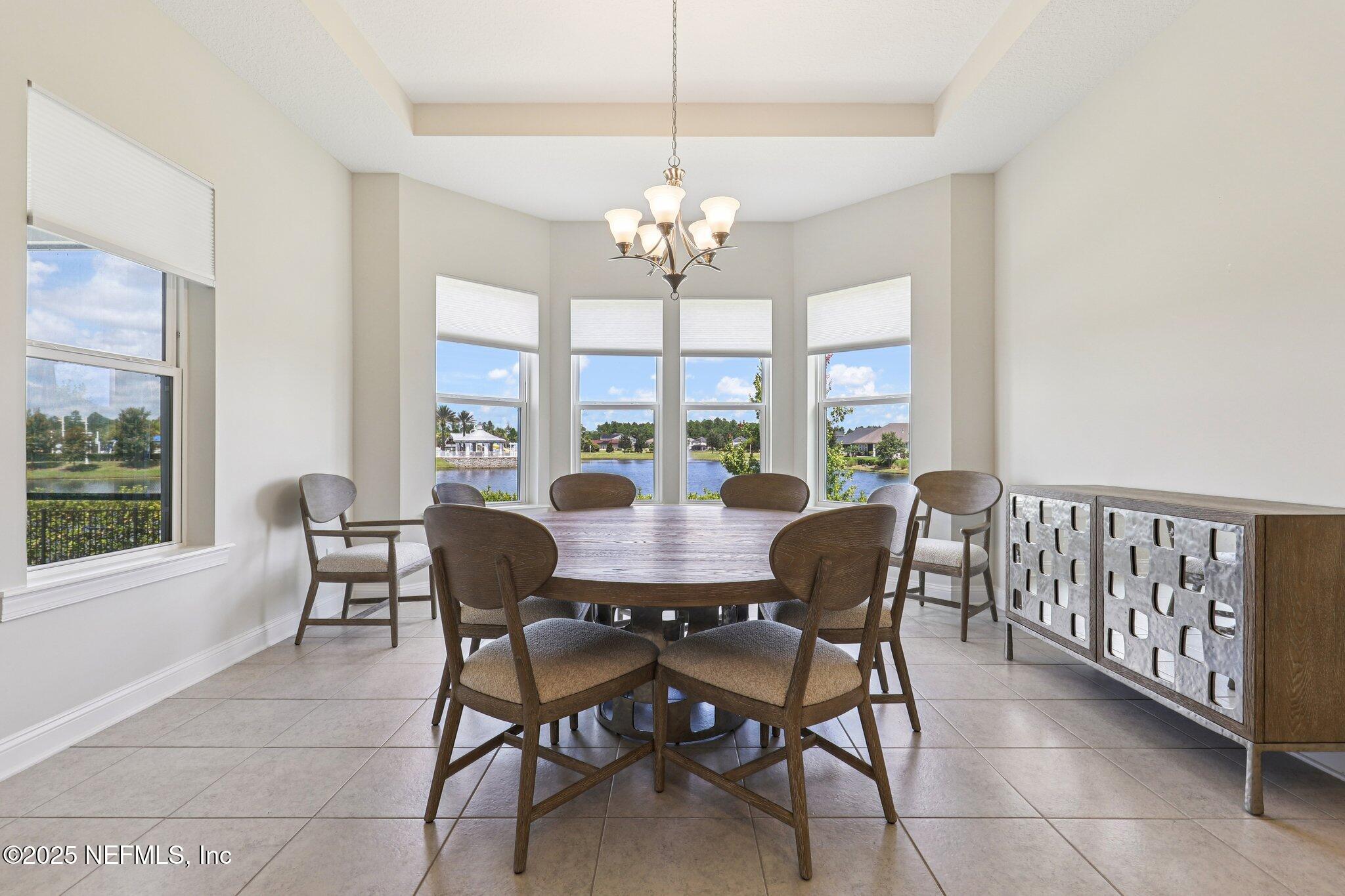 194 Snowbell Court St. Augustine, FL 32095 - Photo 17 of 89 a view of a dining room with furniture a chandelier and wooden floor