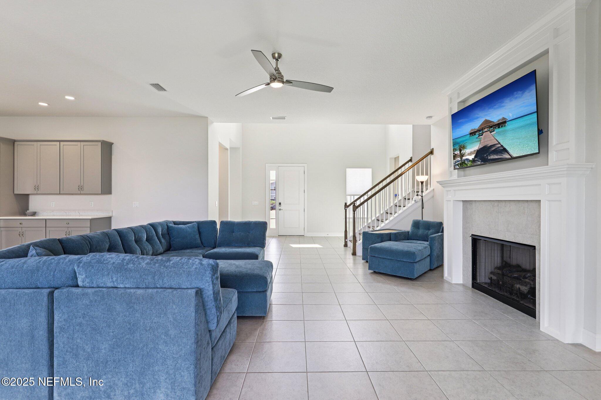 194 Snowbell Court St. Augustine, FL 32095 - Photo 23 of 89 a living room with furniture and a fireplace