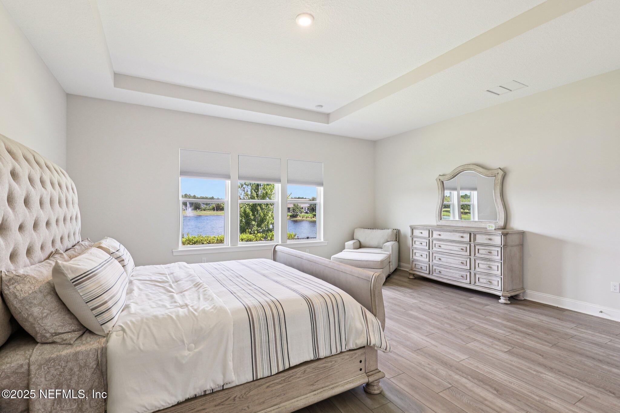 194 Snowbell Court St. Augustine, FL 32095 - Photo 27 of 89 a bedroom with a bed and wooden floor