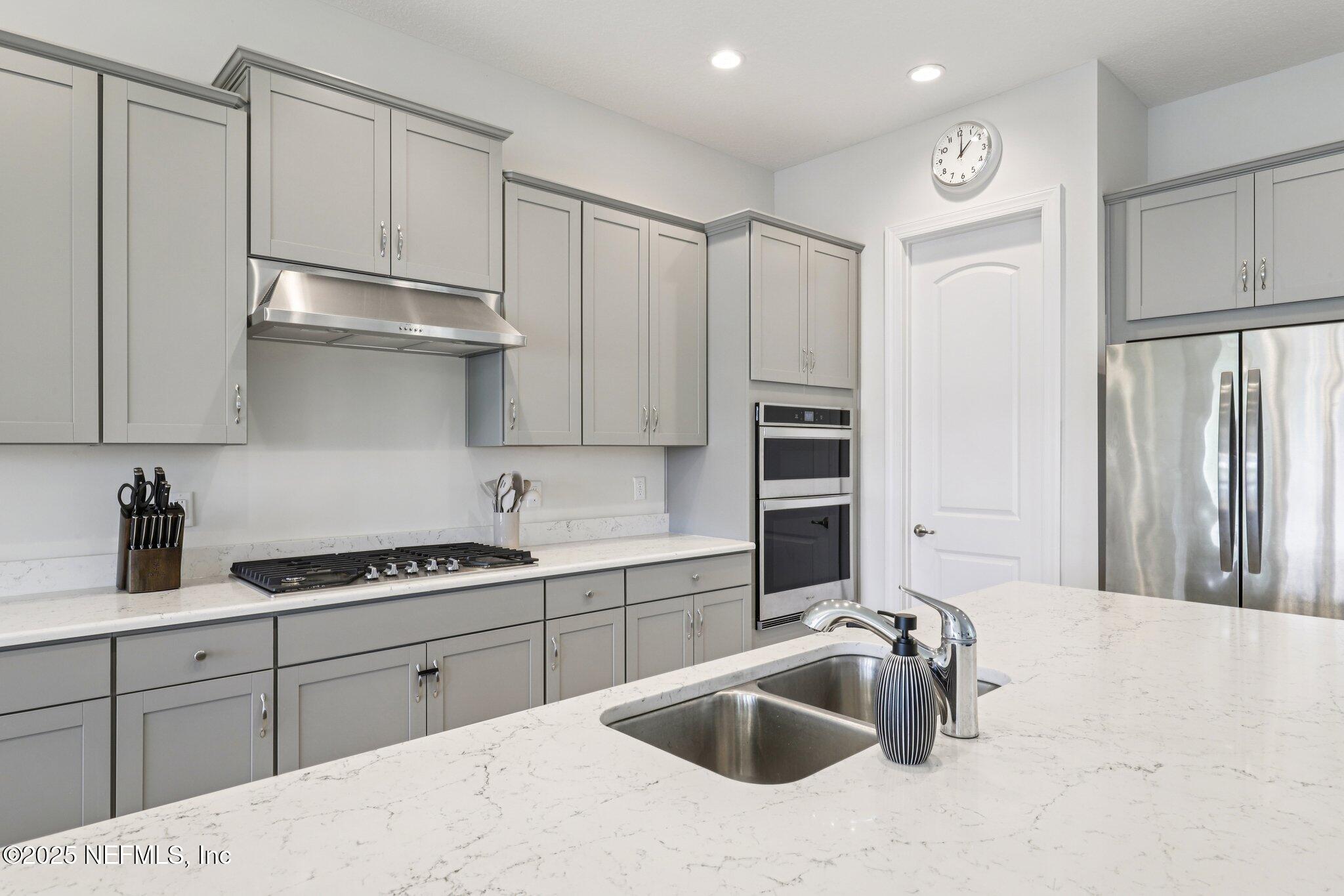 194 Snowbell Court St. Augustine, FL 32095 - Photo 4 of 89 a kitchen with stainless steel appliances a sink stove and refrigerator
