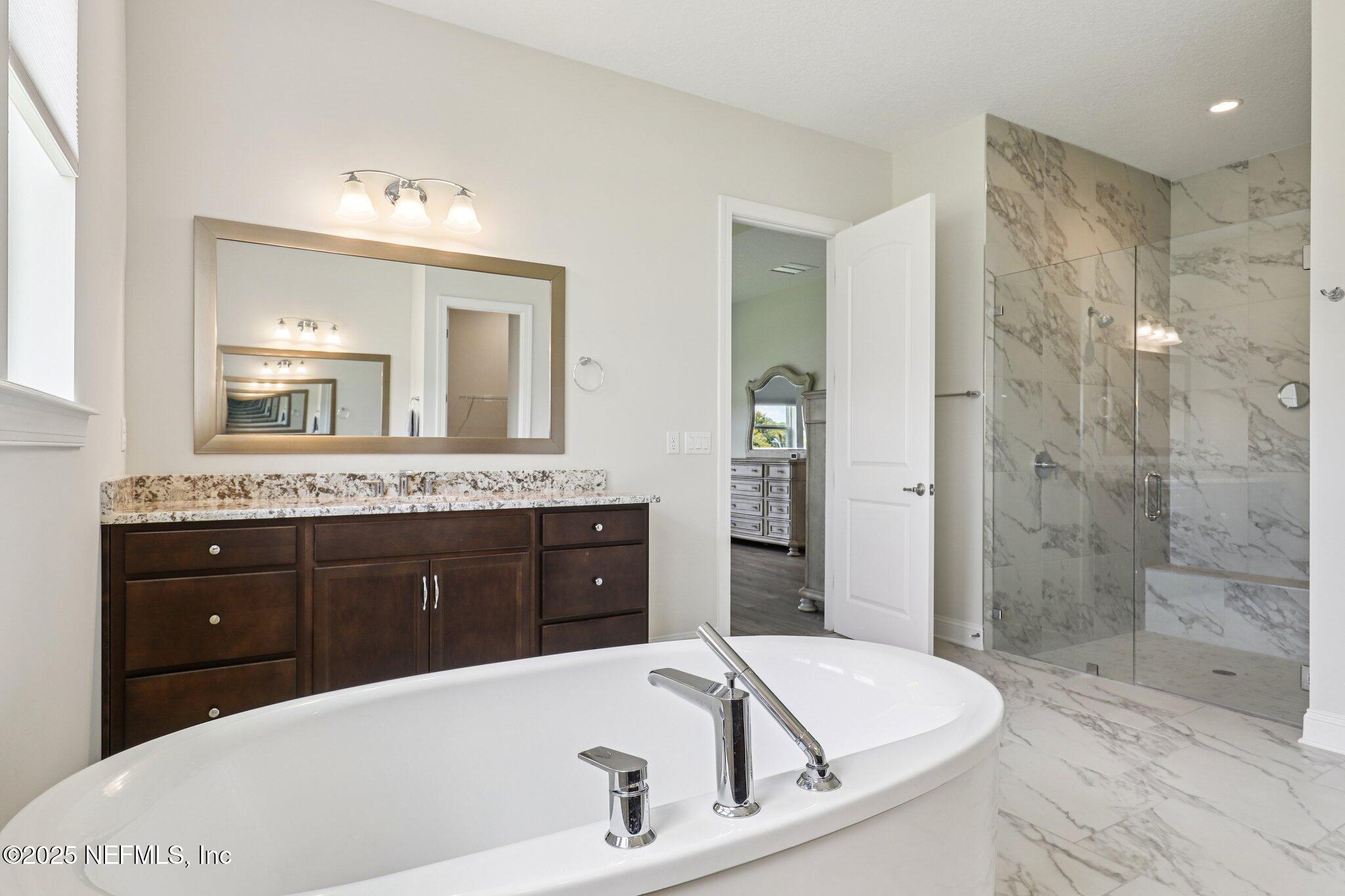 194 Snowbell Court St. Augustine, FL 32095 - Photo 6 of 89 a bathroom with a bathtub sink and mirror