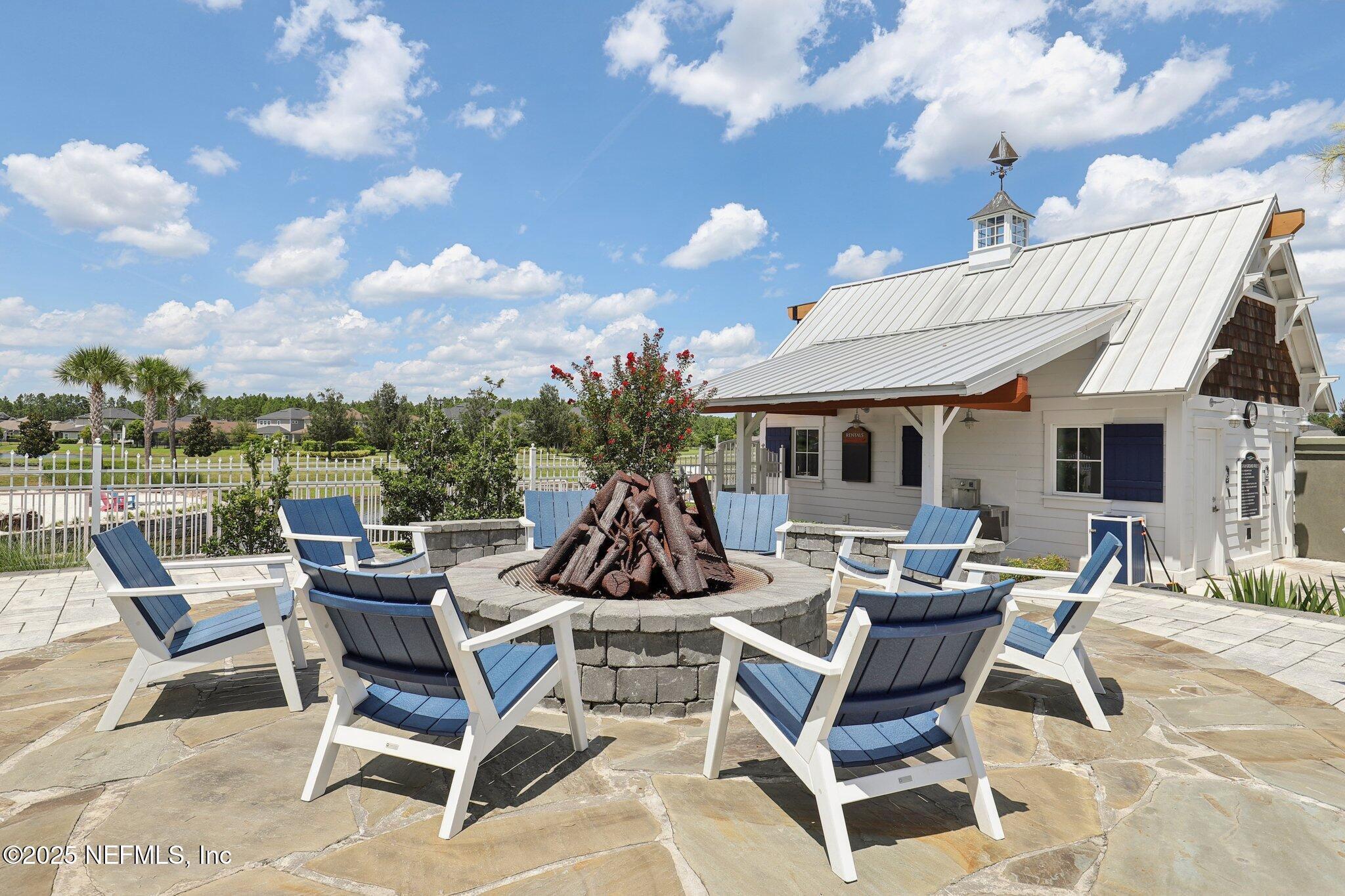 194 Snowbell Court St. Augustine, FL 32095 - Photo 69 of 89 a view of a patio with a dining table and chairs with wooden floor
