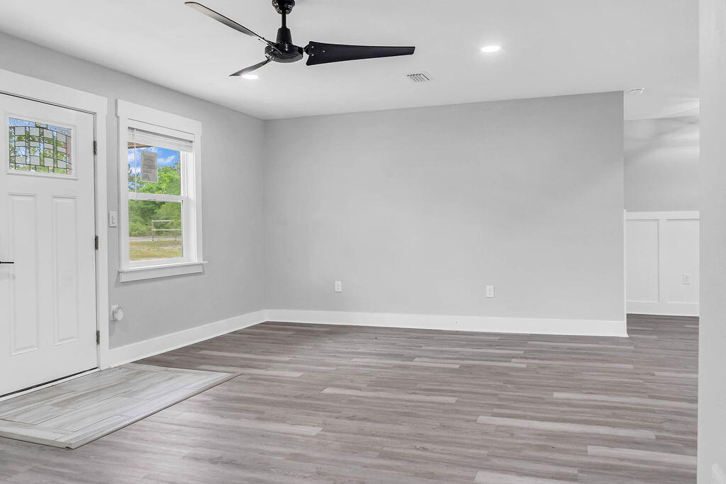 5742 Mt Olive Road Crestview, FL 32539 - Photo 15 of 59 wooden floor in an empty room with a window