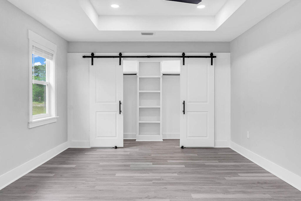 5742 Mt Olive Road Crestview, FL 32539 - Photo 17 of 59 a view of an empty room with wooden floor closet and windows