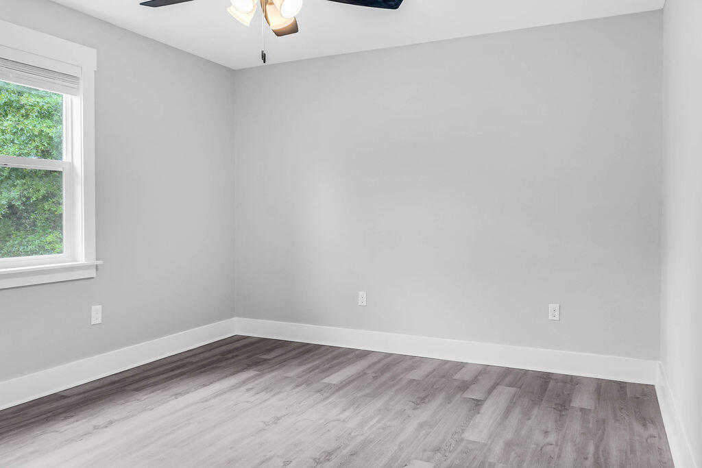 5742 Mt Olive Road Crestview, FL 32539 - Photo 23 of 59 a view of an empty room with wooden floor and a window