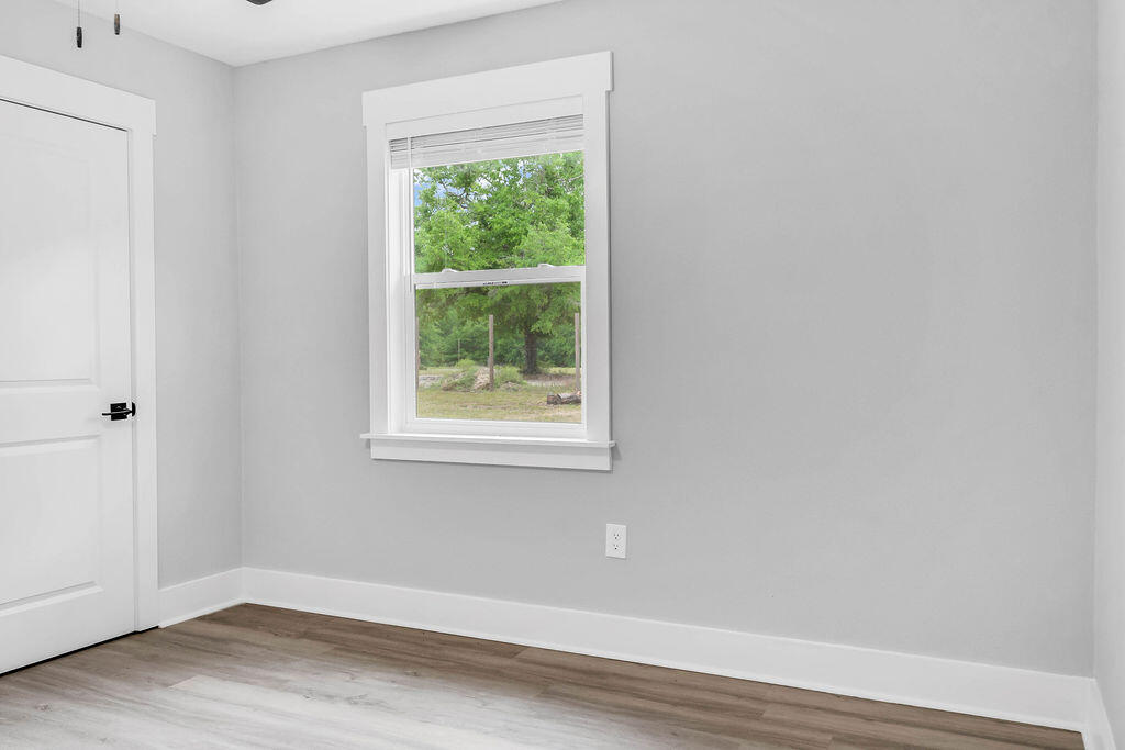 5742 Mt Olive Road Crestview, FL 32539 - Photo 25 of 59 a view of a small space with wooden floor and a window
