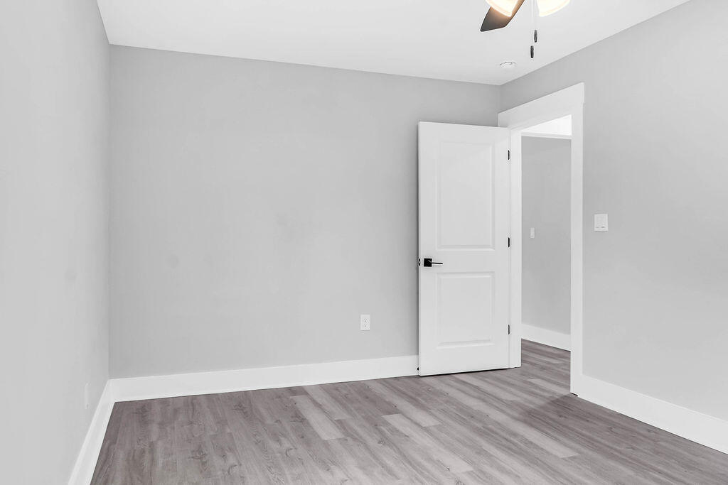 5742 Mt Olive Road Crestview, FL 32539 - Photo 31 of 59 a view of an empty room with wooden floor