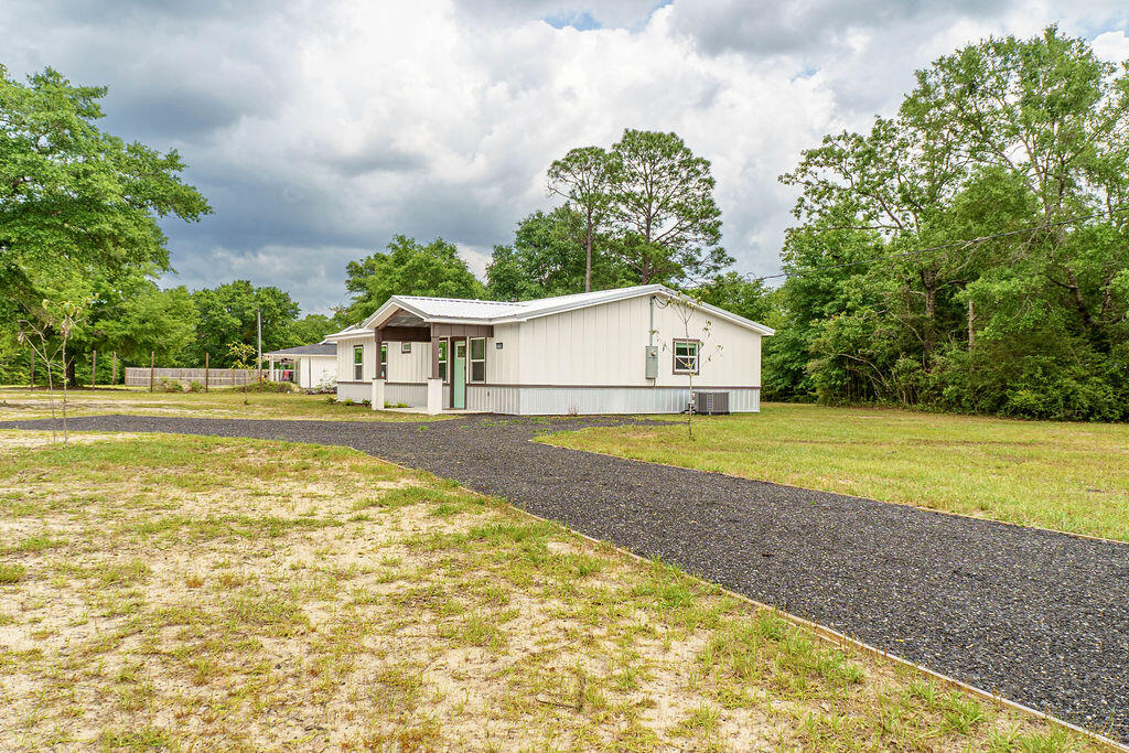 5742 Mt Olive Road Crestview, FL 32539 - Photo 43 of 59 a house with swimming pool in front of it