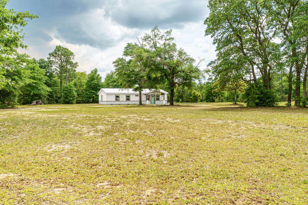 5742 Mt Olive Road Crestview, FL 32539 - Photo 45 of 59 a view of a swimming pool with an outdoor space and seating area