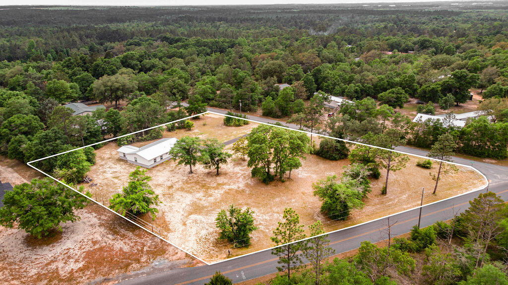 5742 Mt Olive Road Crestview, FL 32539 - Photo 46 of 59 an aerial view of a house with a yard and lake view