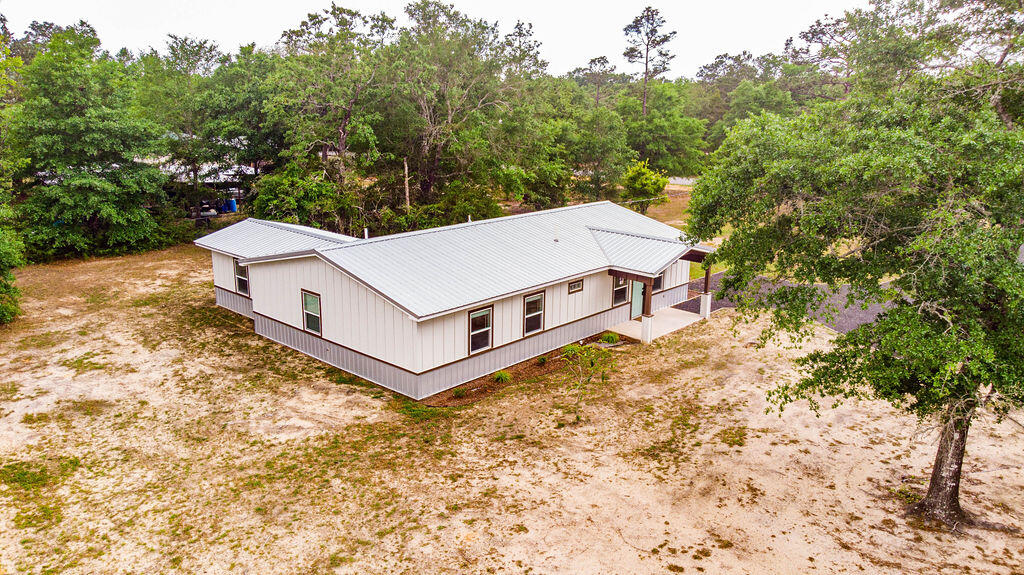 5742 Mt Olive Road Crestview, FL 32539 - Photo 57 of 59 a view of a terrace with a small yard and large trees
