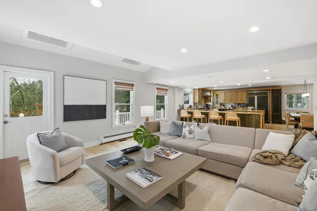 a living room with furniture and view of kitchen
