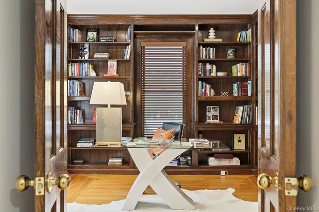 a bedroom with furniture and a large window