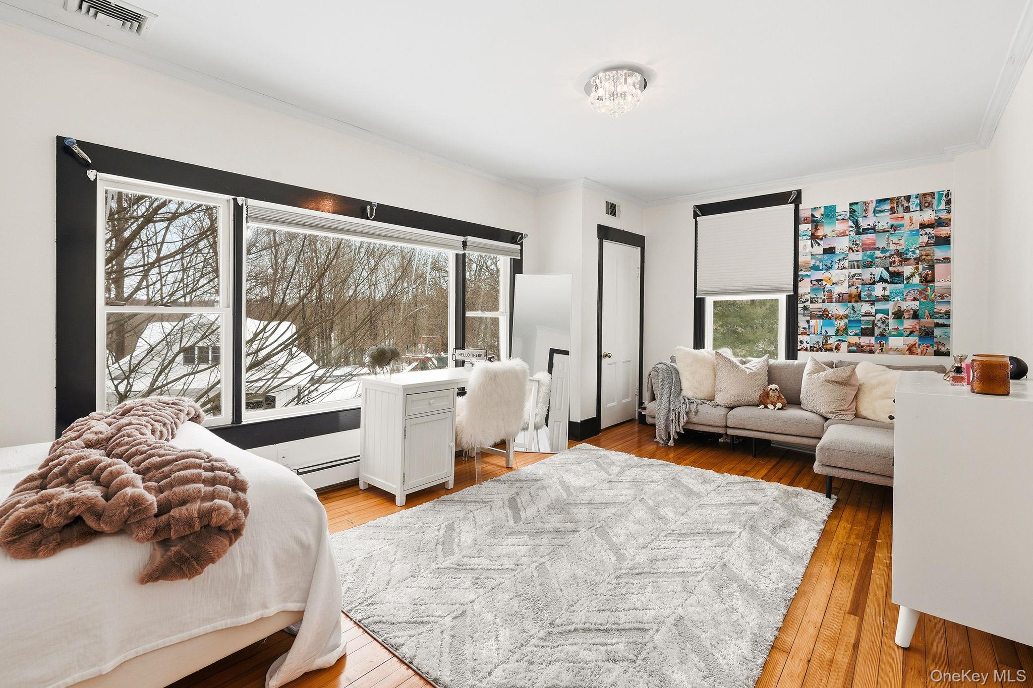 276 Quaker Road Chappaqua, NY 10514 - Photo 30 of 41 a bedroom with furniture and a large window