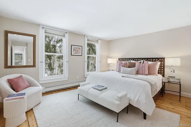a living room with furniture a large window and a potted plant