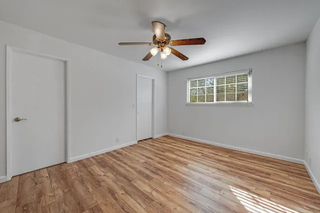a view of an empty room and wooden floor