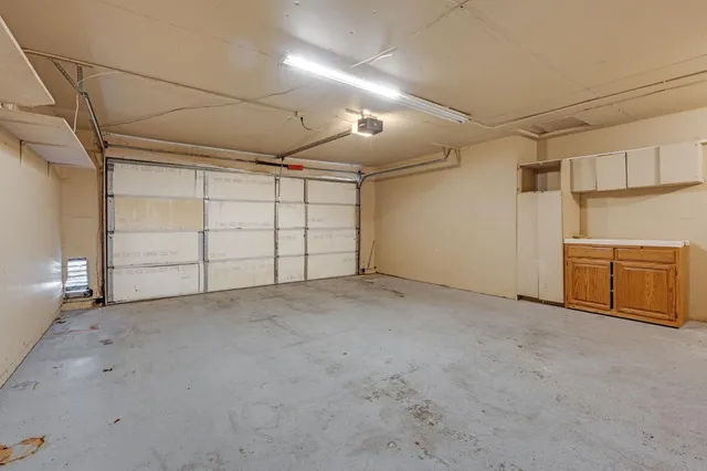 a view of a house with backyard and a tree