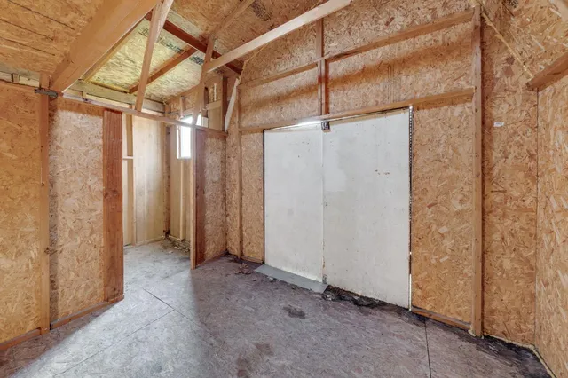 a kitchen with granite countertop a sink dishwasher stove and cabinets with wooden floor