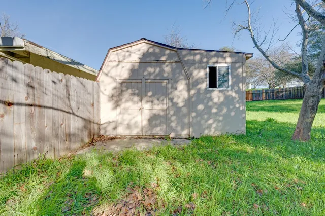 a bedroom with a bed and a wooden floor
