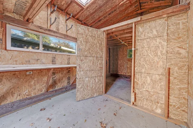 a view of a backyard with wooden fence