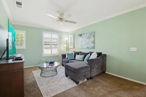 a living room with furniture and a chandelier