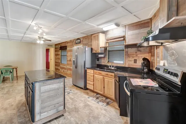 a kitchen with granite countertop a sink appliances and cabinets