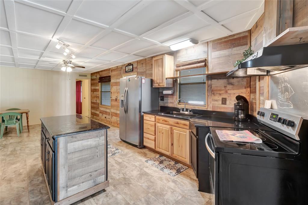 1409 Ridge Road Tavares, FL 32778 - Photo 11 of 36 a kitchen with granite countertop a sink appliances and cabinets